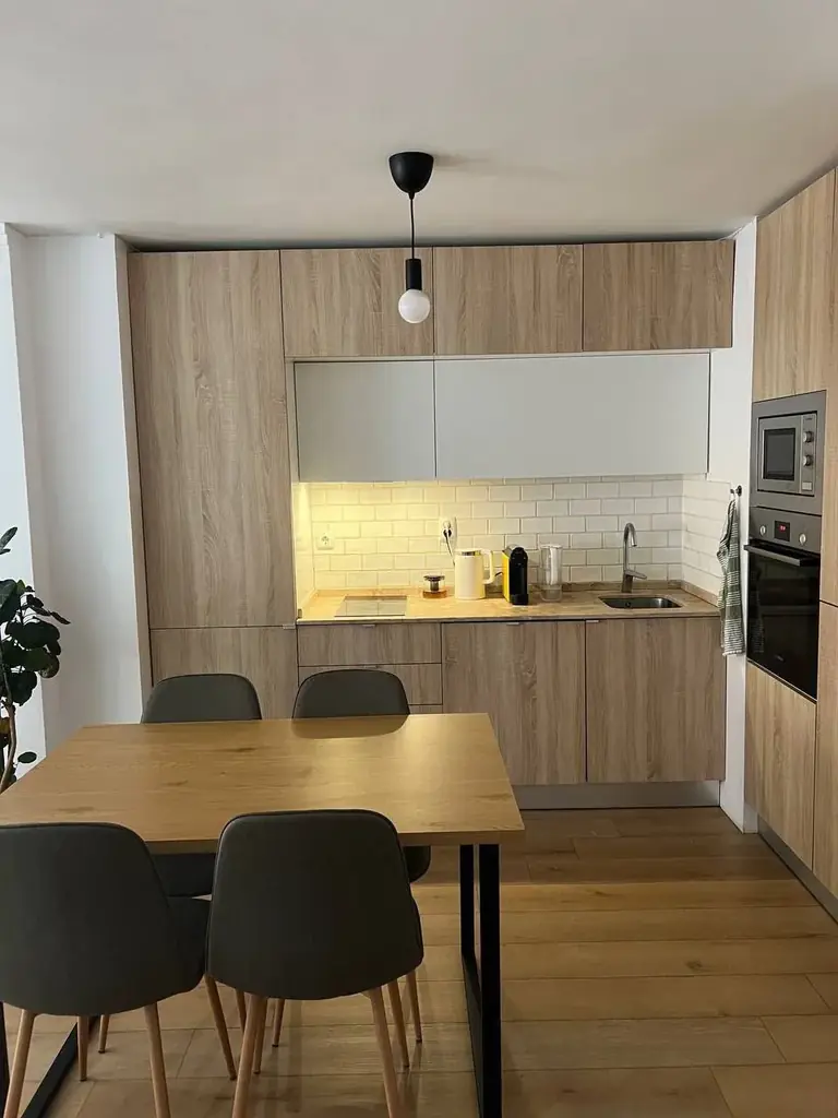 Продам обеденный стол JYSK AABENRAA (120 × 80 см) и два мягких стула с серо-зелёной обивкой.