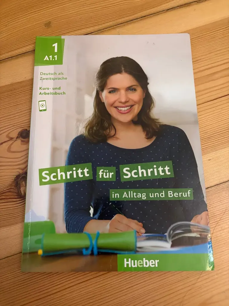 Продаю учебник немецкого «Schritt für Schritt A1.1». На некоторых страницах есть пометки карандашом.